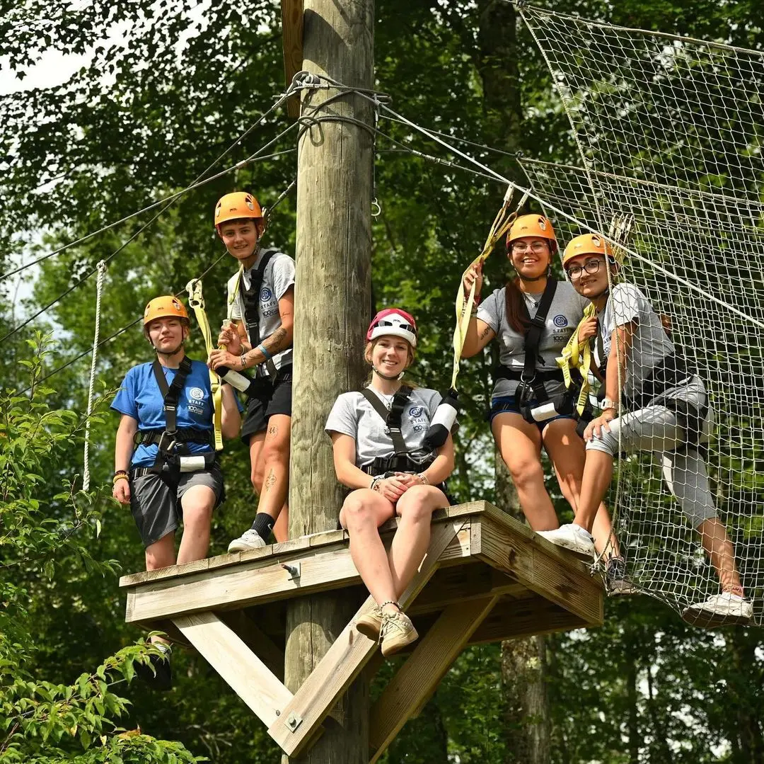 Jóvenes practicando escalada sobre un árbol.