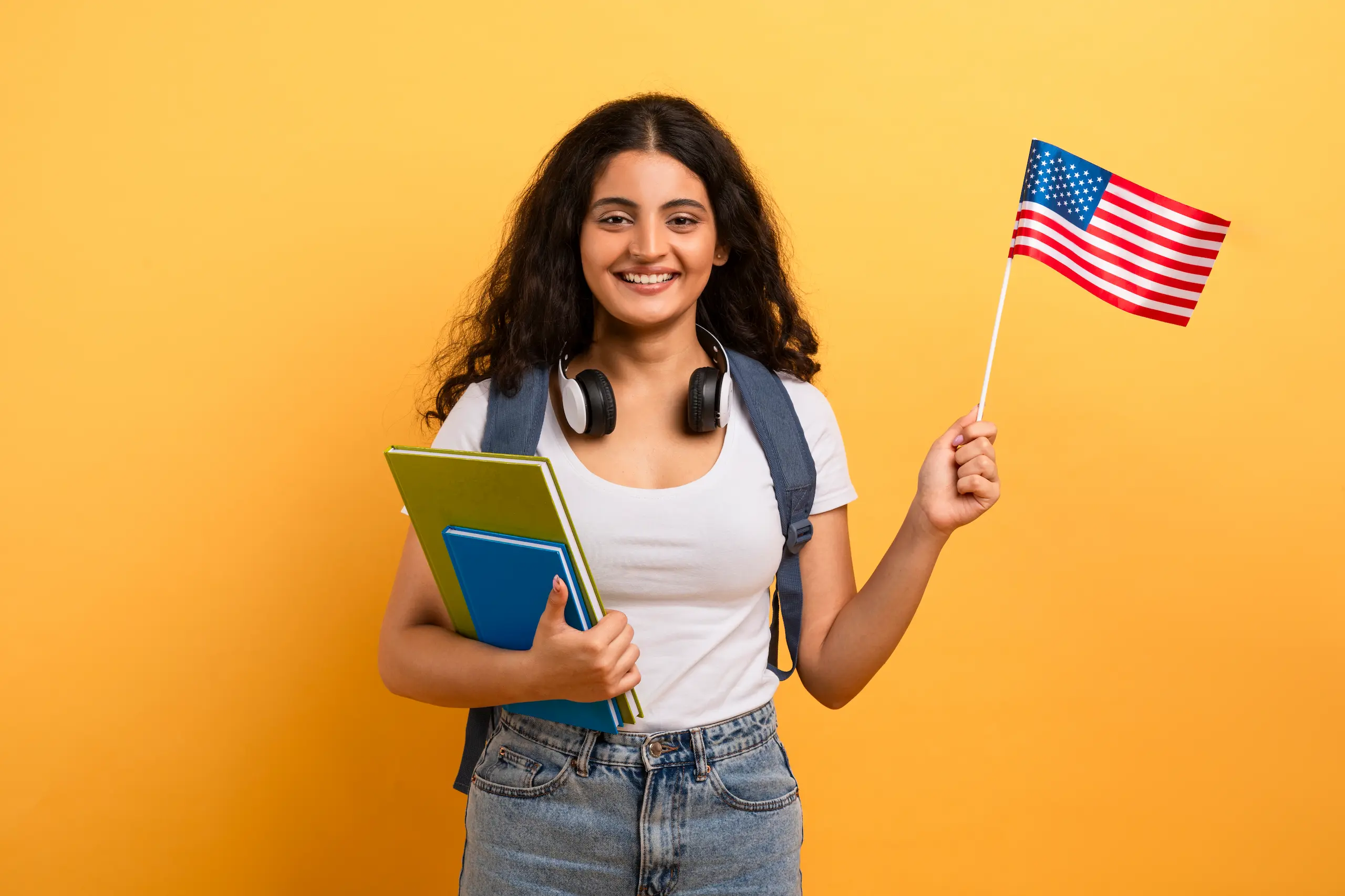 Mujer feliz con una bandera estadounidense | Work Experience